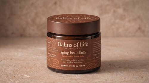 Aging Beautifully jar with the Balms of Life Apothecary label on a stone plinth